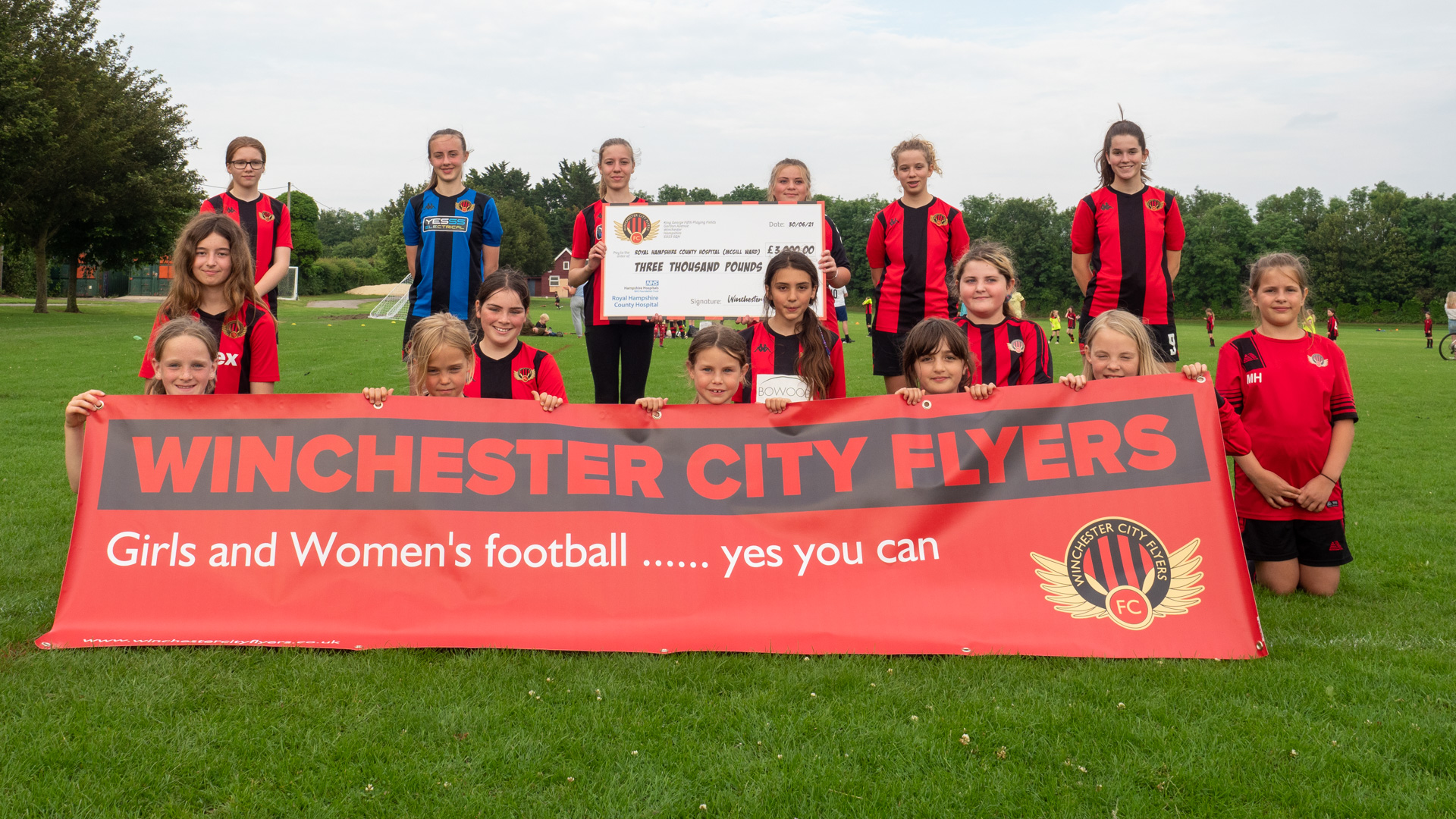 Photo 1 Winchester Flyers football club with cheque.jpg